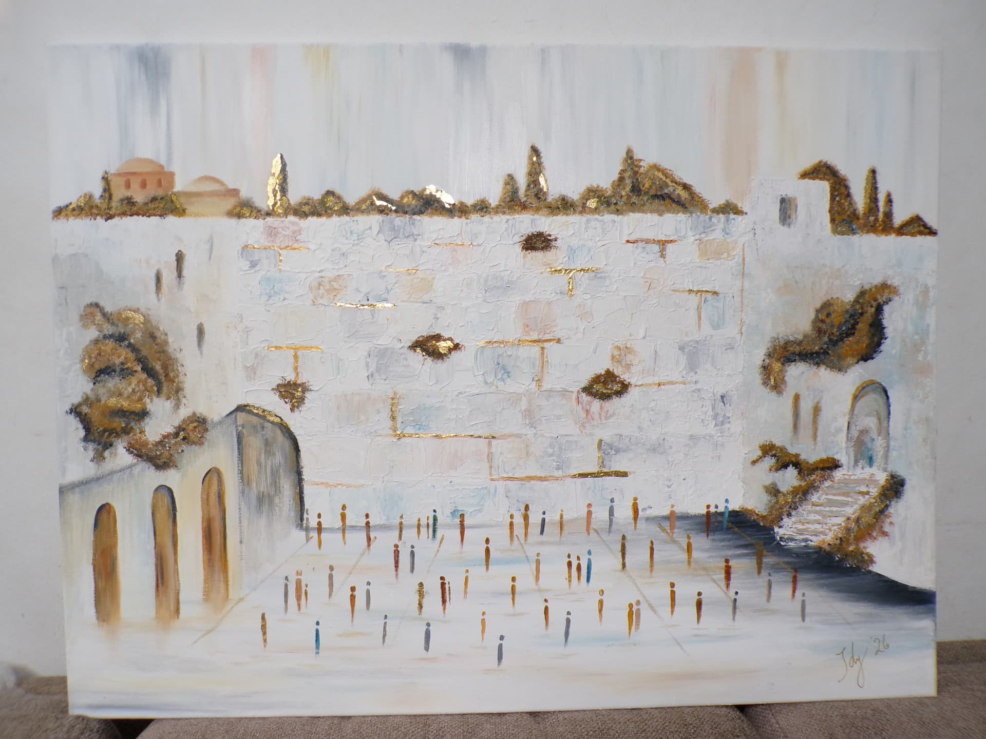 Student painting of the Kotel with gold-leaf greenery and many figures